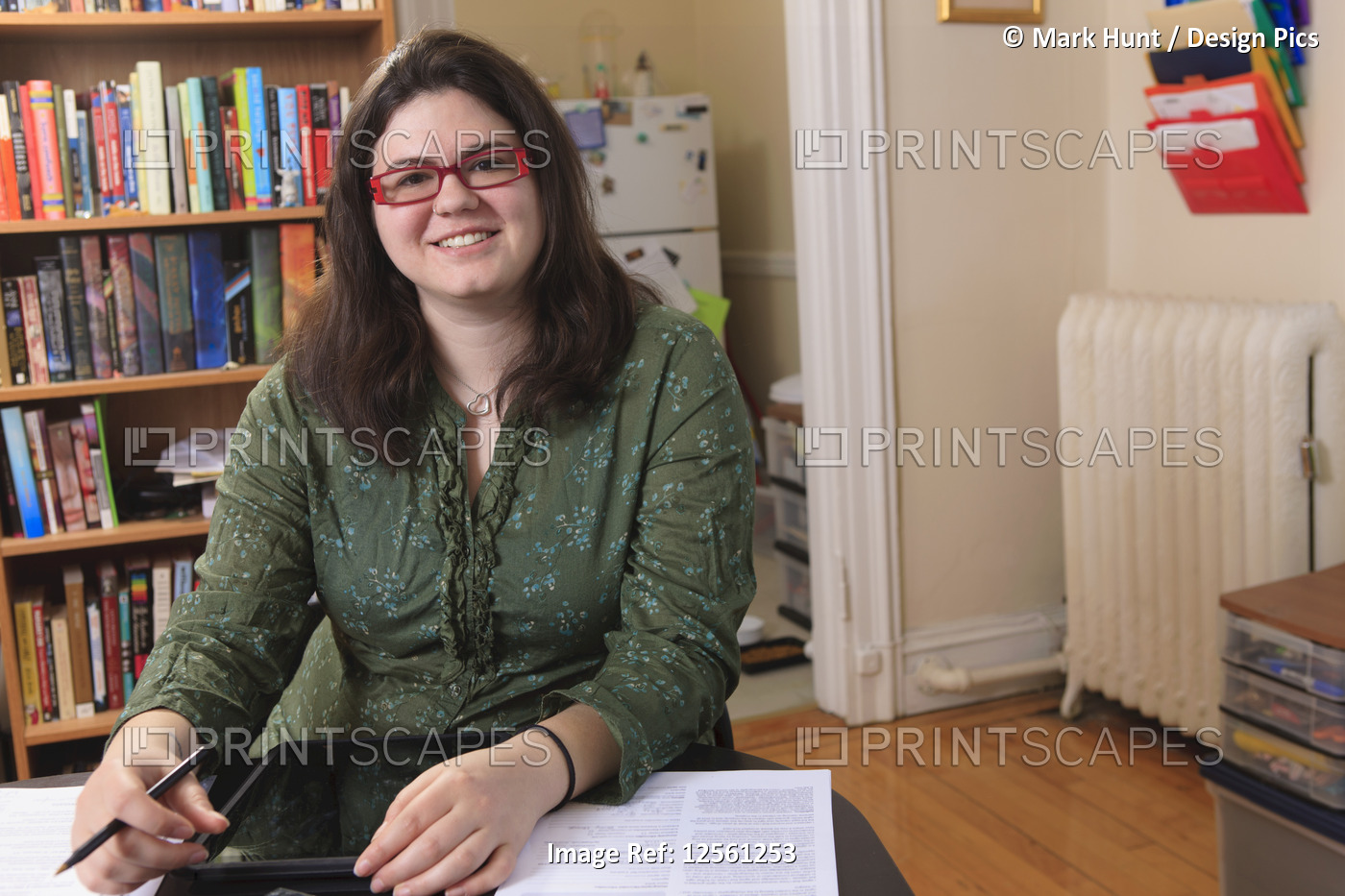 Woman with Asperger syndrome working in her home office with her tablet
