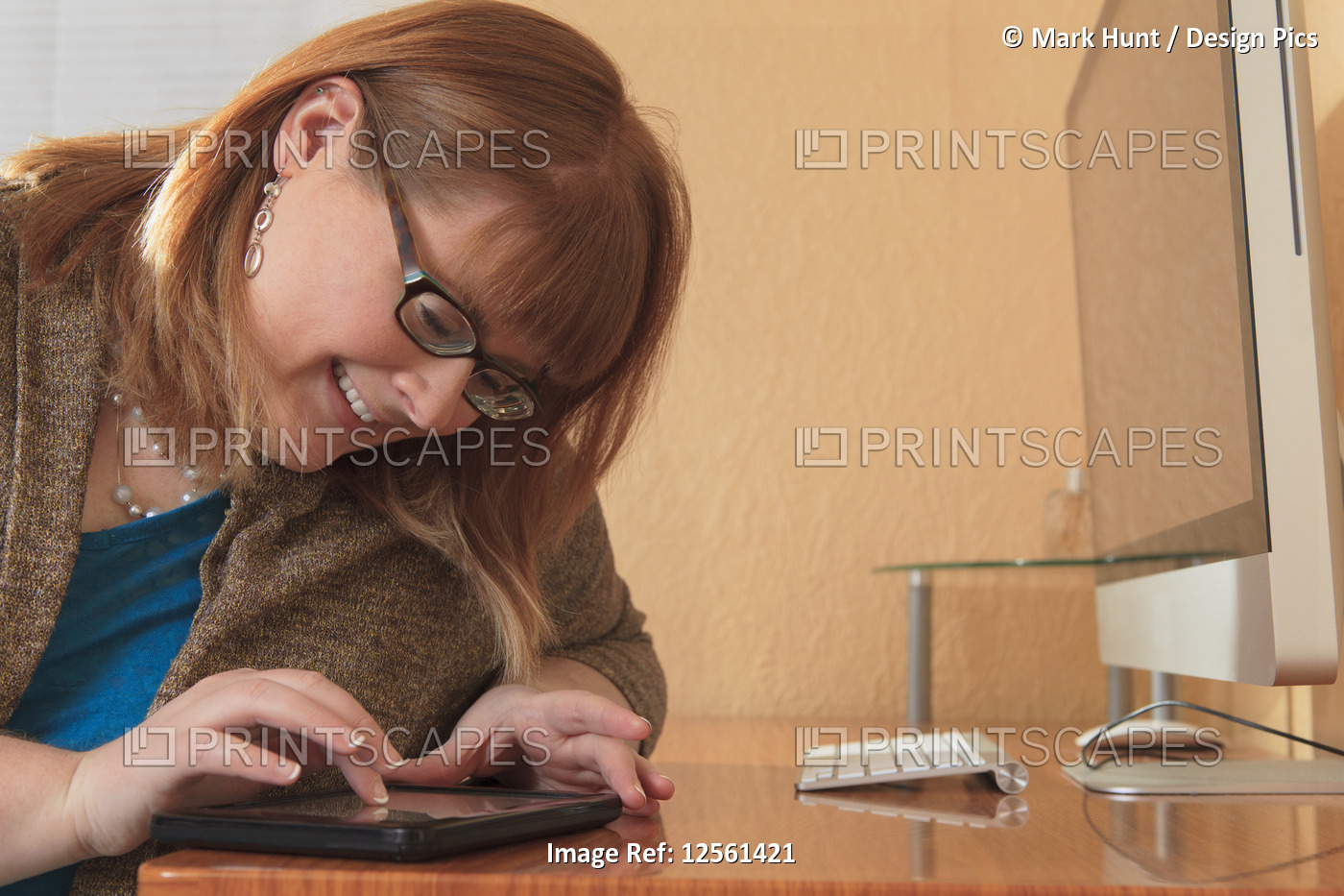 Woman who is legally blind using her tablet in her home