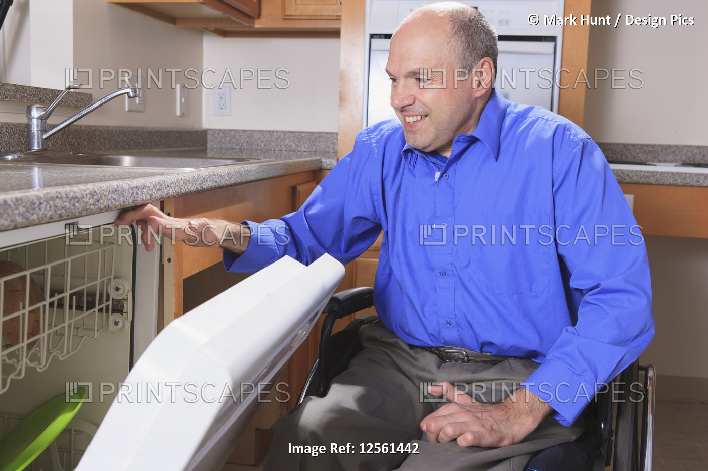 Man with Friedreich's Ataxia and deformed hands using his dishwasher