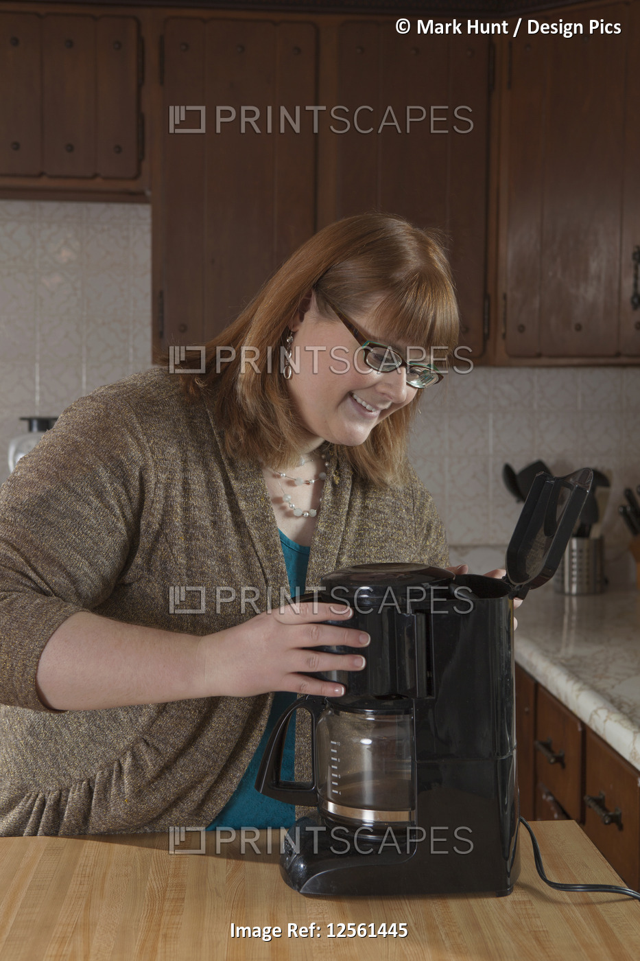 Woman who is legally blind making coffee in her kitchen