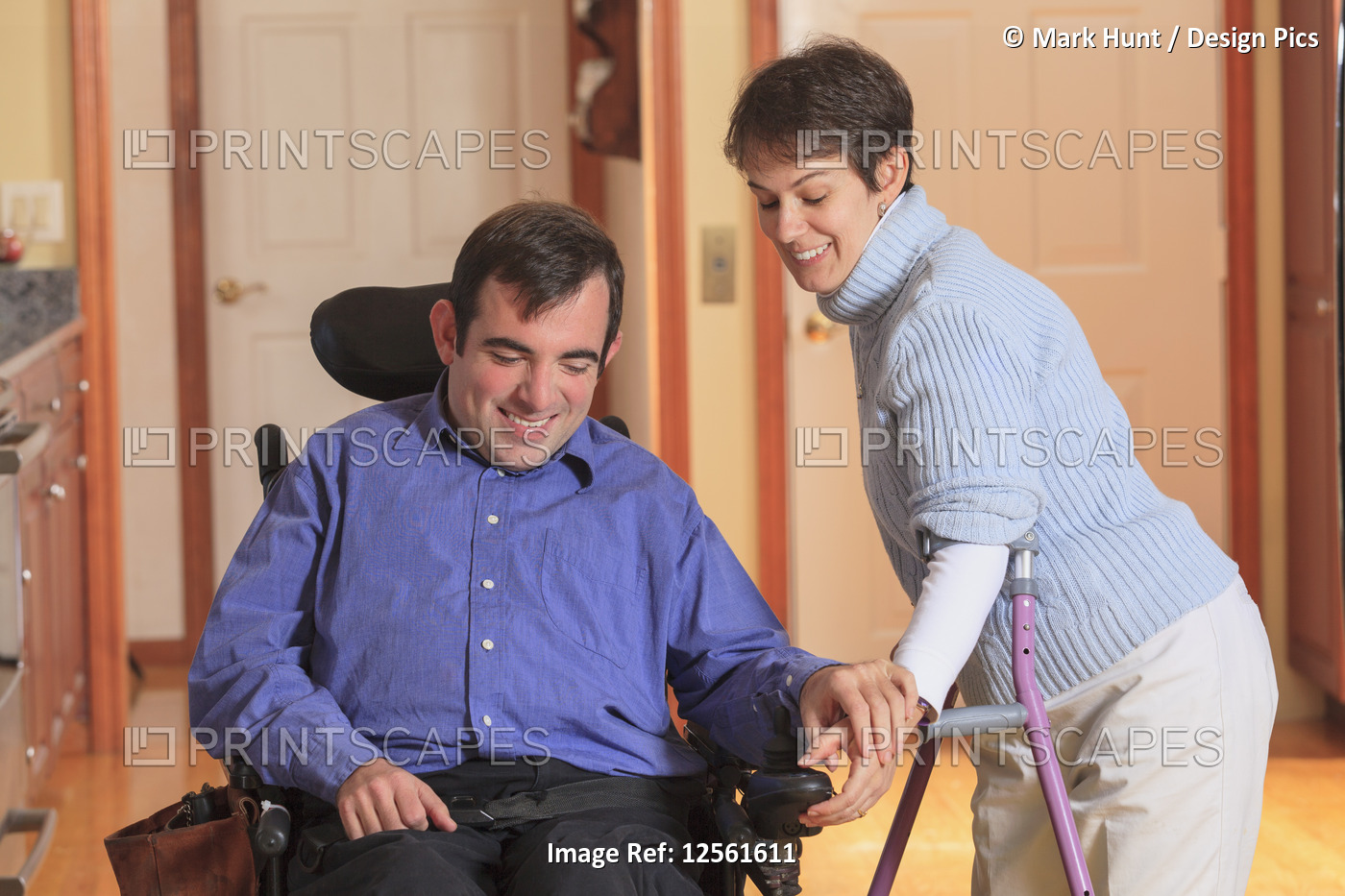 Woman with Cerebral Palsy using crutches and helping her husband with Cerebral ...