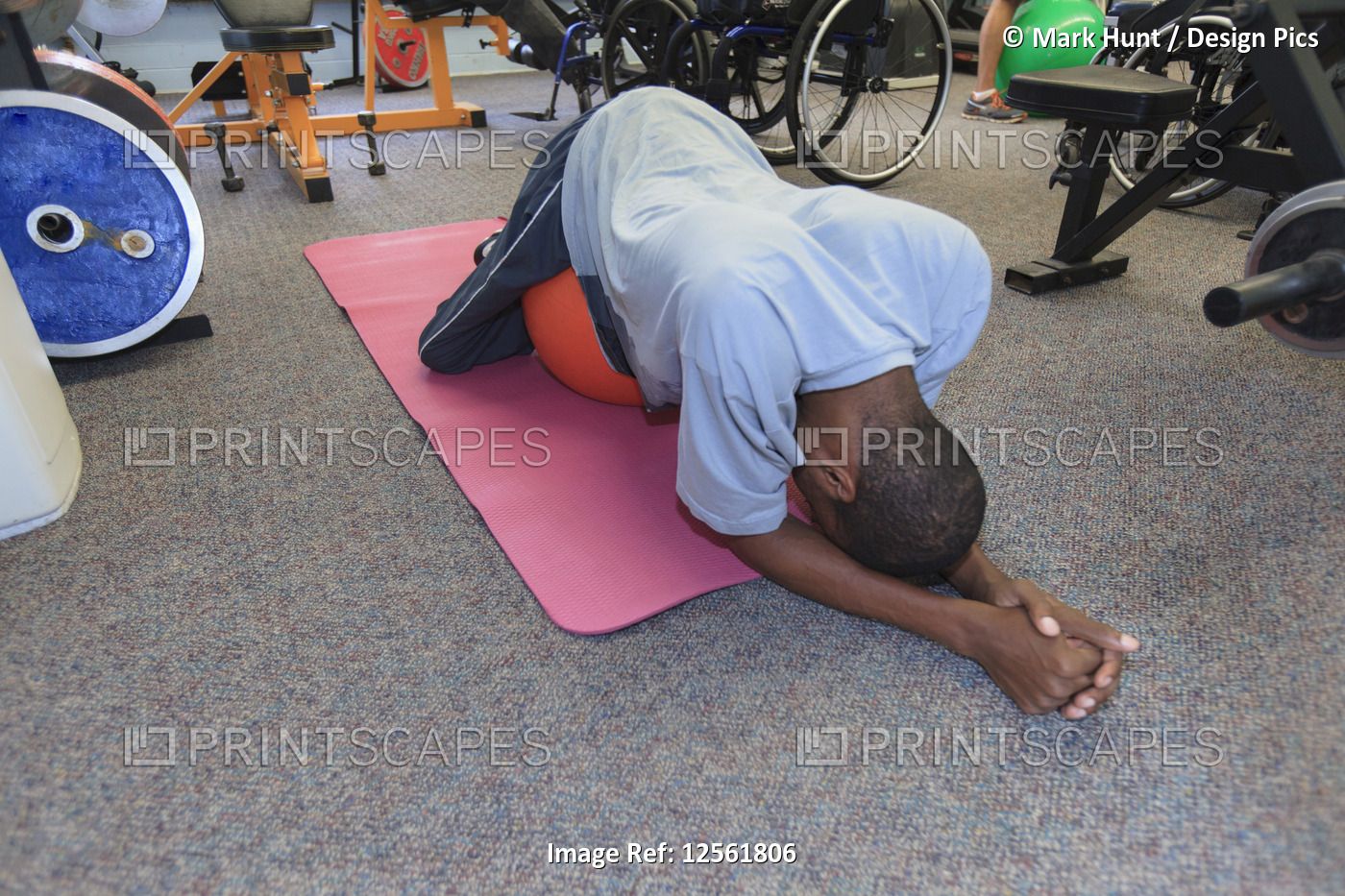 Man who had Spinal Meningitis and can't walk resting on exercise ball