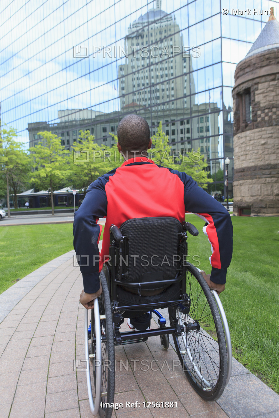 Man in wheelchair who had  Spinal Meningitis moving independently in the city
