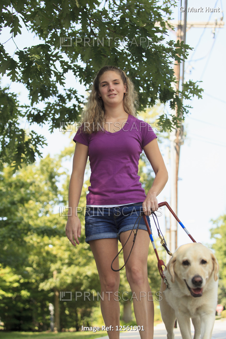 Woman with visual impairment walking with her service dog