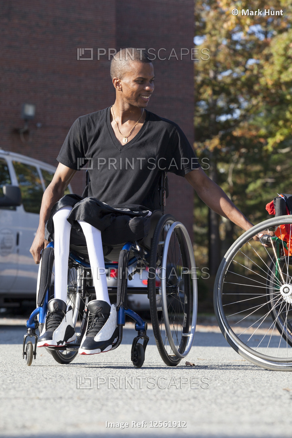 Man who had Spinal Meningitis in wheelchair entering his accessible vehicle