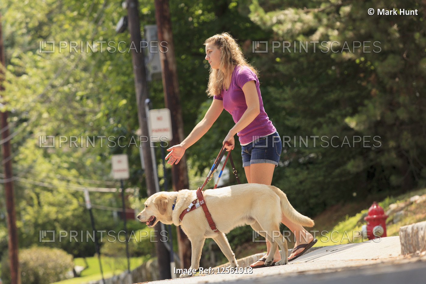 Student with visual impairment directing her service dog to turn