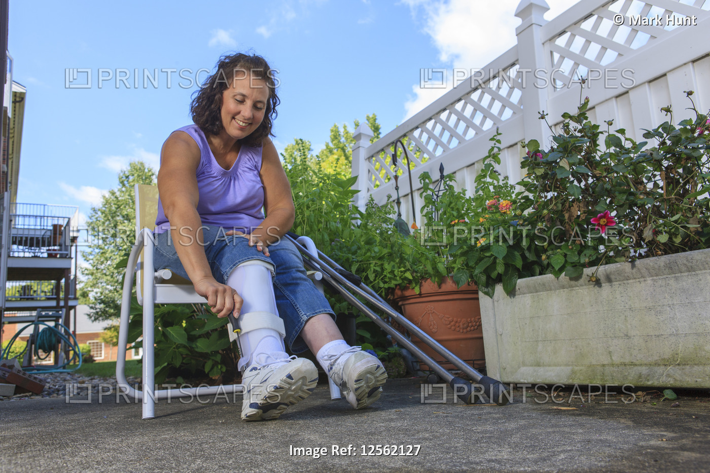 Woman with Spina Bifida adjusting leg brace so she can walk