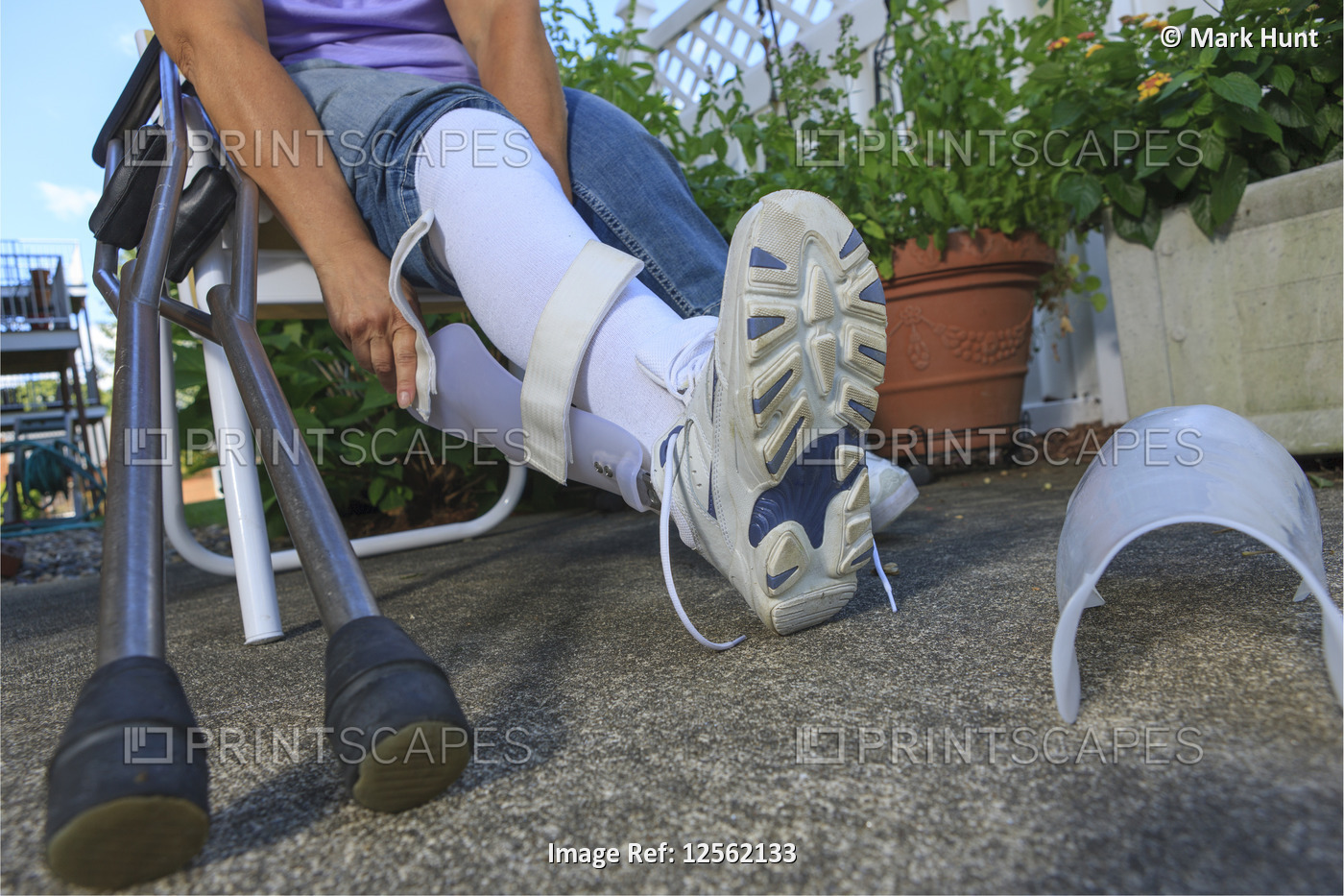 Woman with Spina Bifida adjusting leg brace so she can walk
