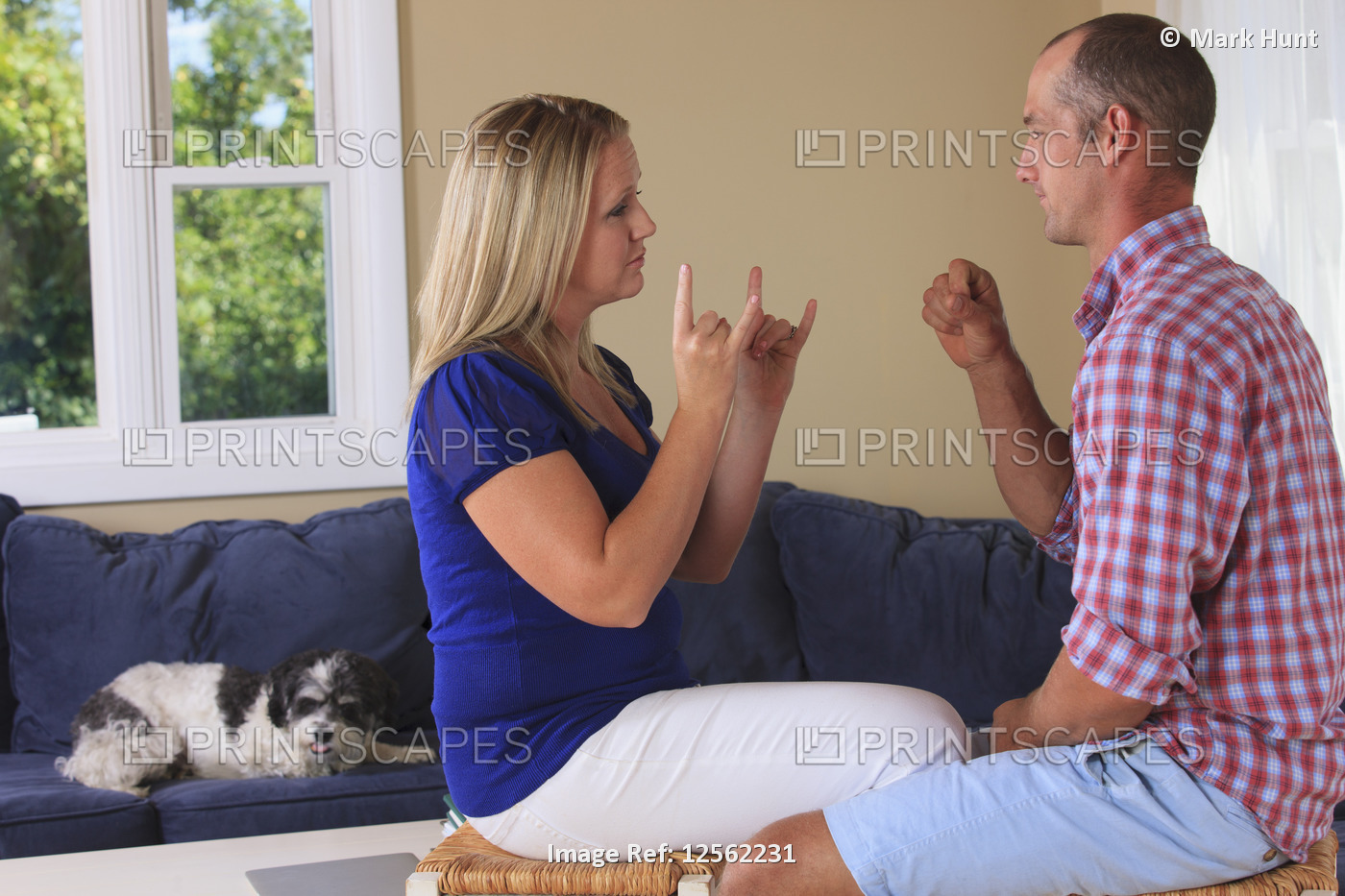 Husband and wife with hearing impairments signing 'camping' in American sign ...