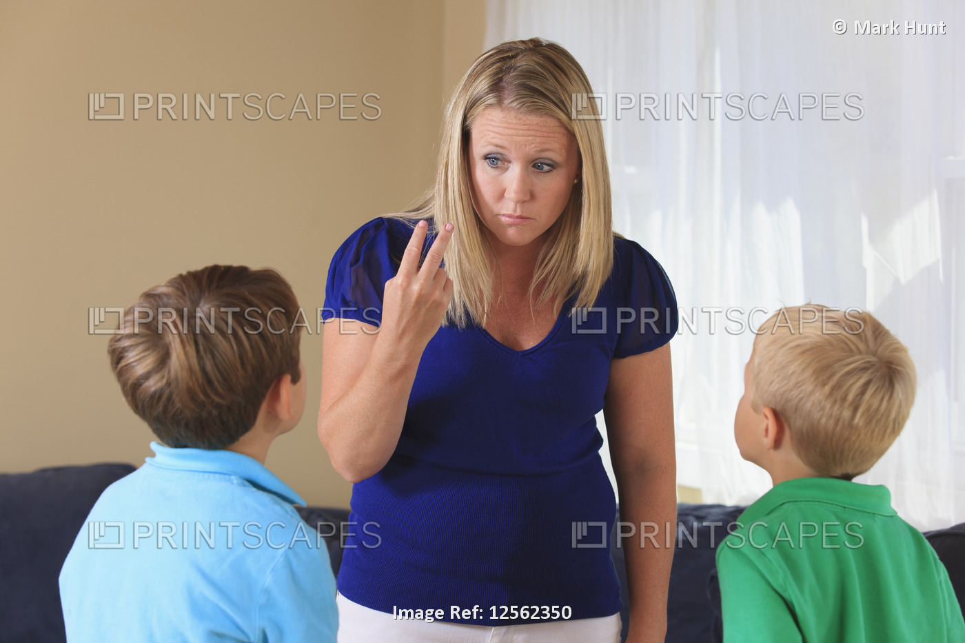 Mother and sons with hearing impairments signing 'look at me' in American sign ...