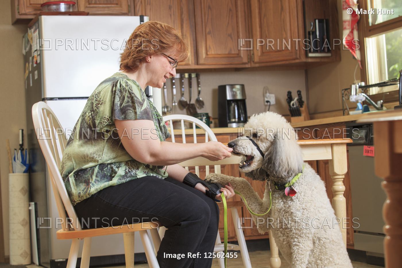 Woman with RSD feeding her service dog