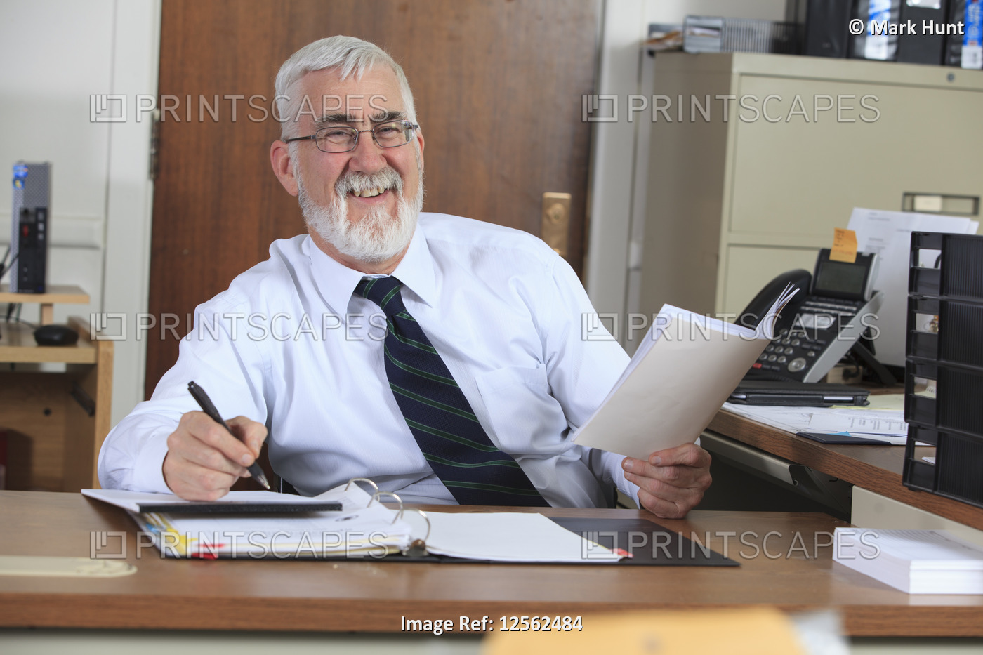 Man with Muscular Dystrophy in a wheelchair working in an office