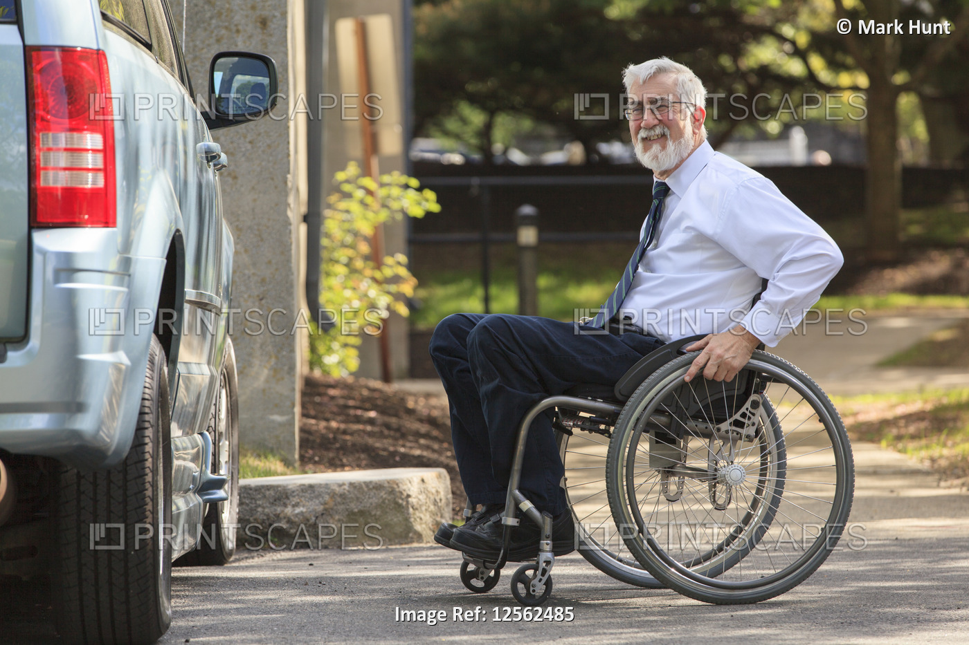 Man with Muscular Dystrophy in a wheelchair entering his accessible van in the ...