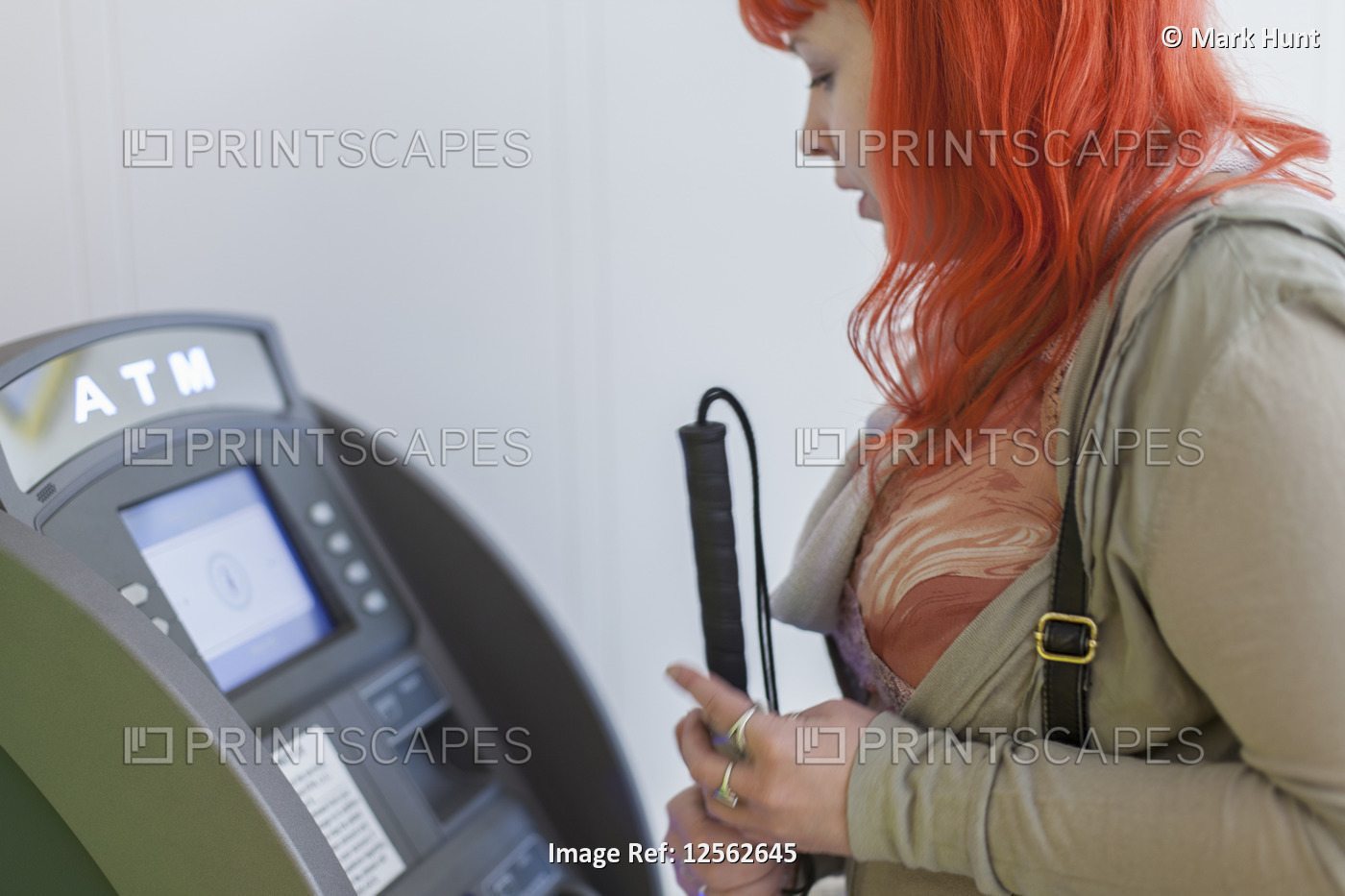 Young blind woman using a bank ATM