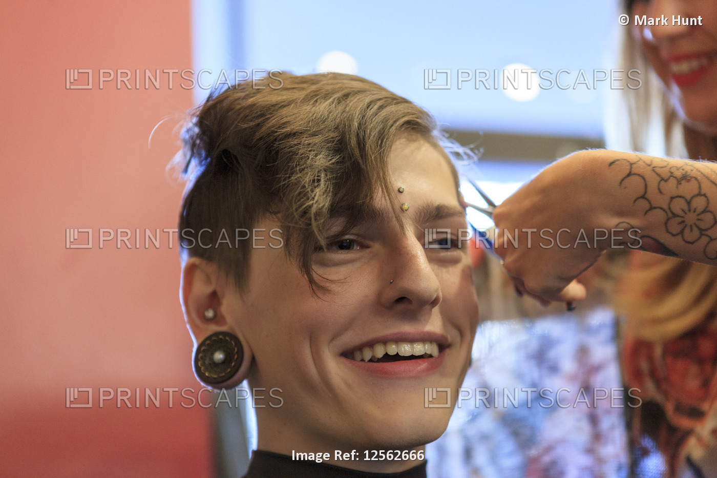 Stylish man with a spinal cord injury at a hair salon getting a hair cut