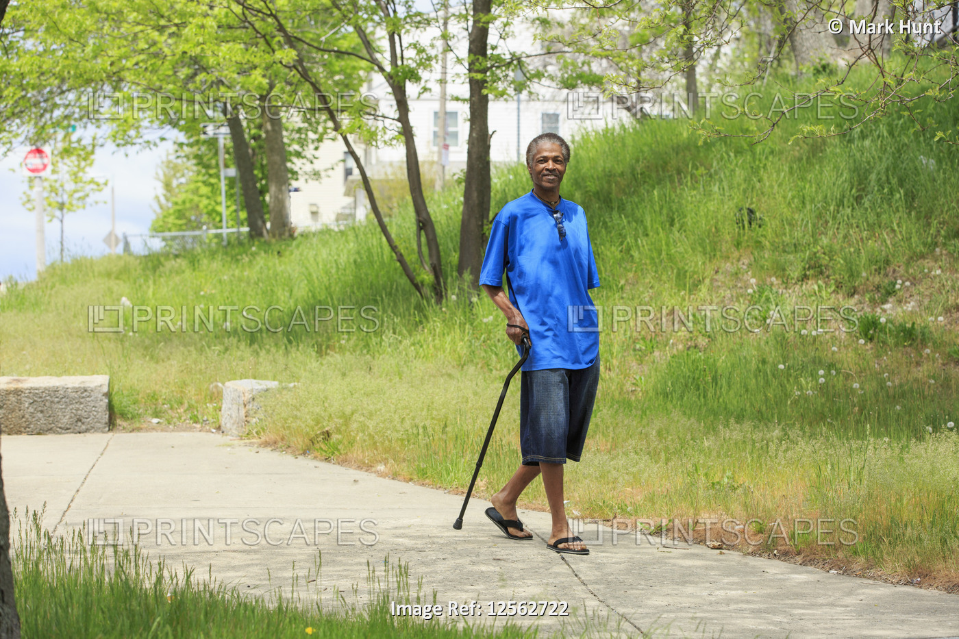 Man with Traumatic Brain Injury taking a walk with his cane