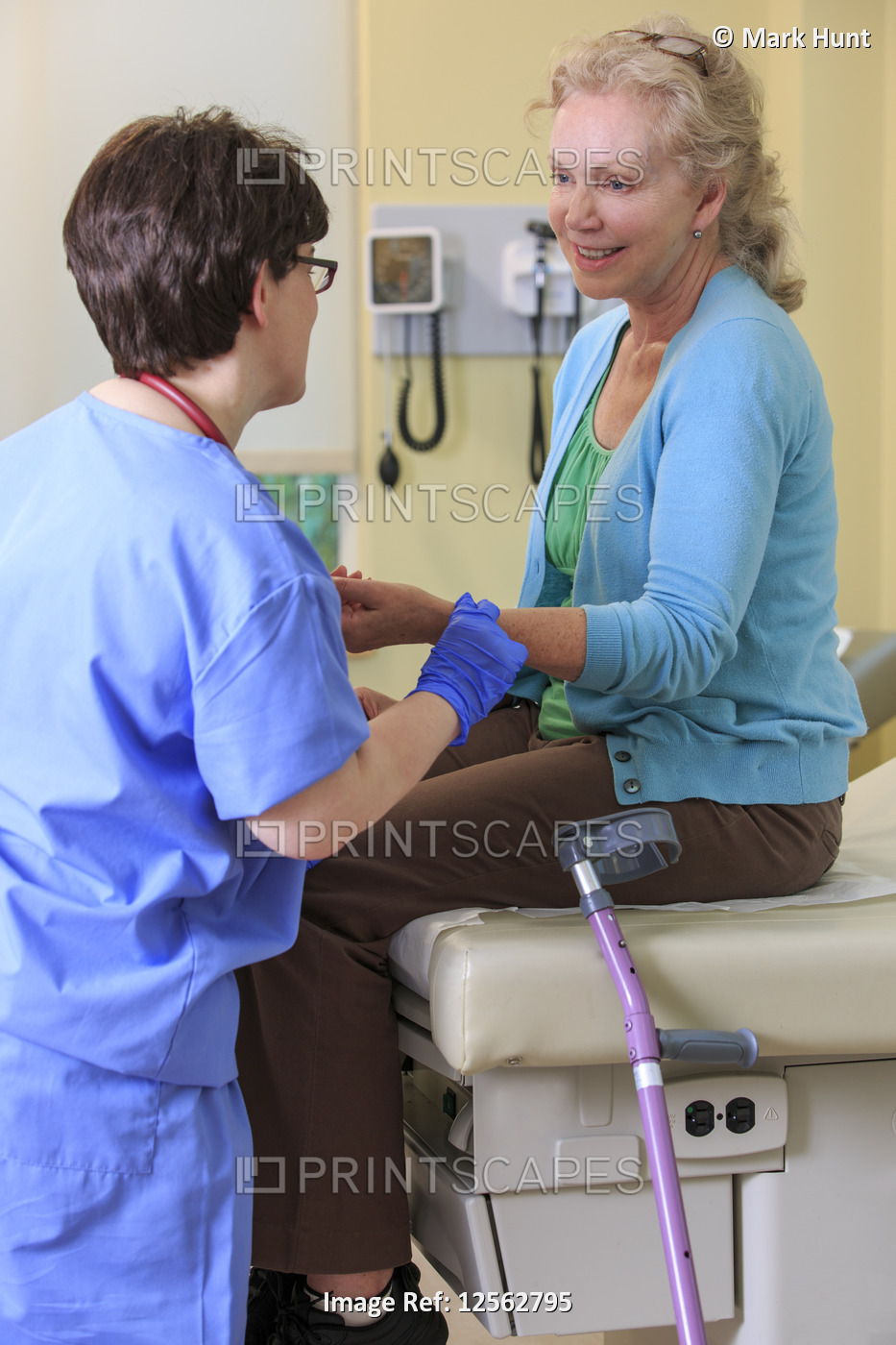 Nurse with Cerebral Palsy checking a patient's pulse in a clinic