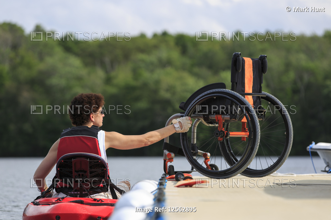Woman with a Spinal Cord Injury learning how to use a kayak