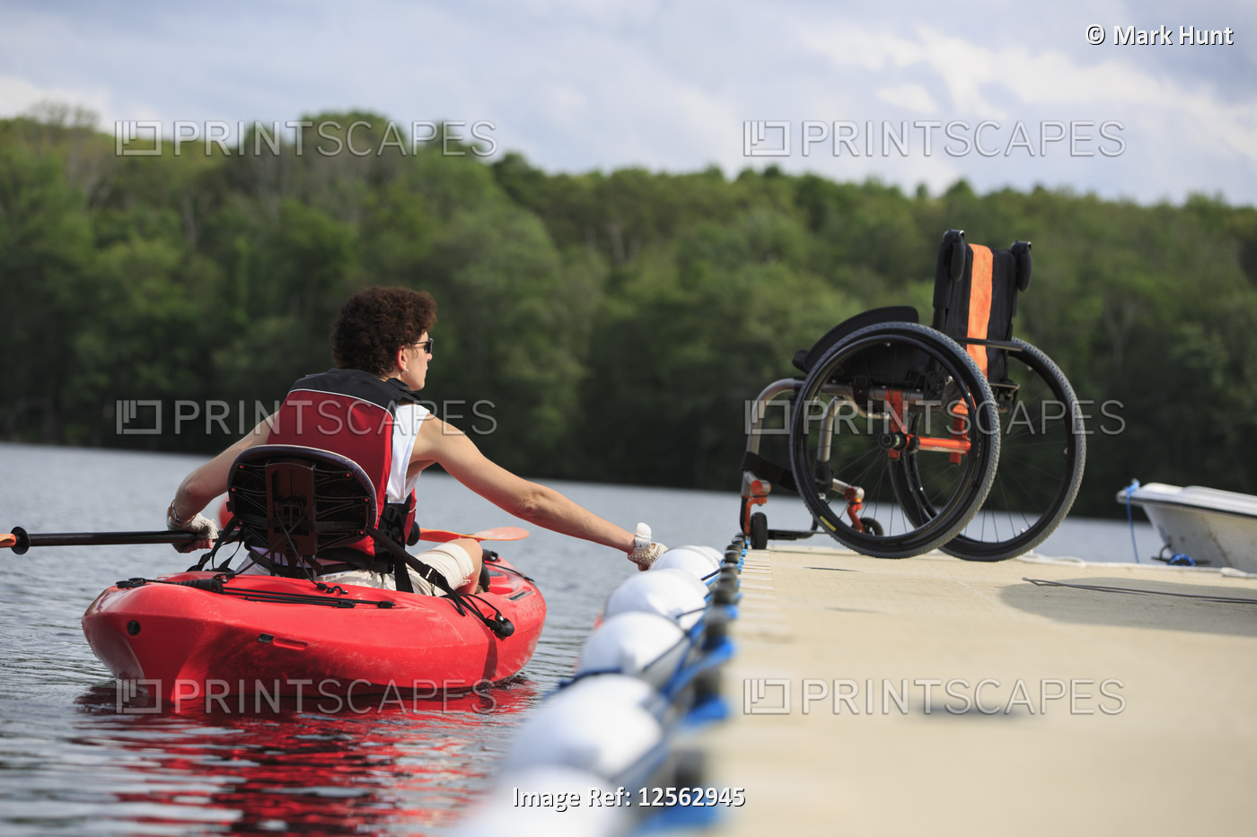 Woman with a Spinal Cord Injury learning how to use a kayak
