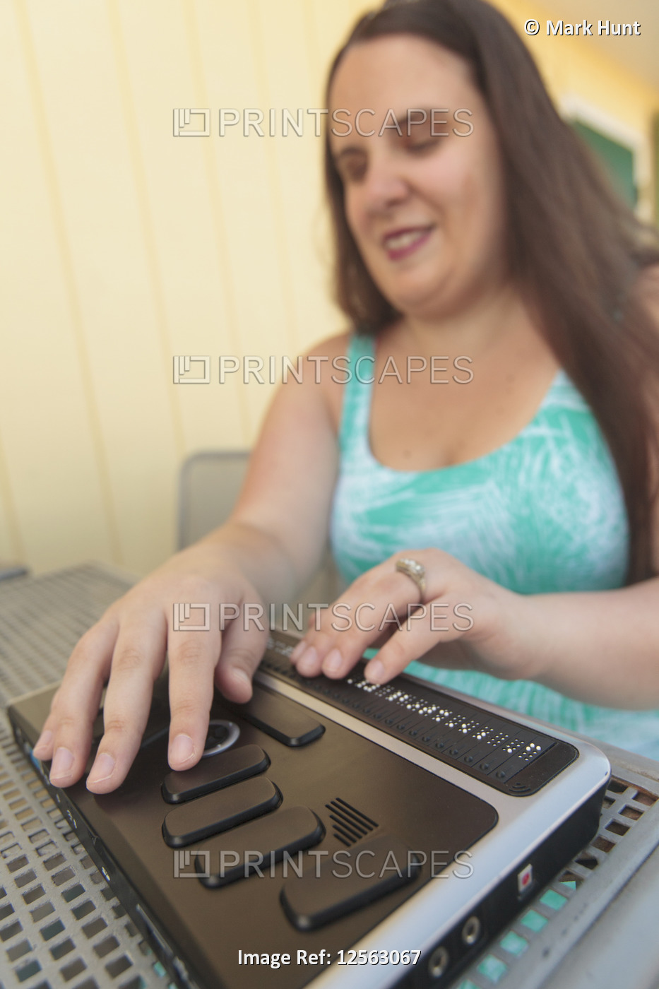 Blind woman using her assistive technology to communicate