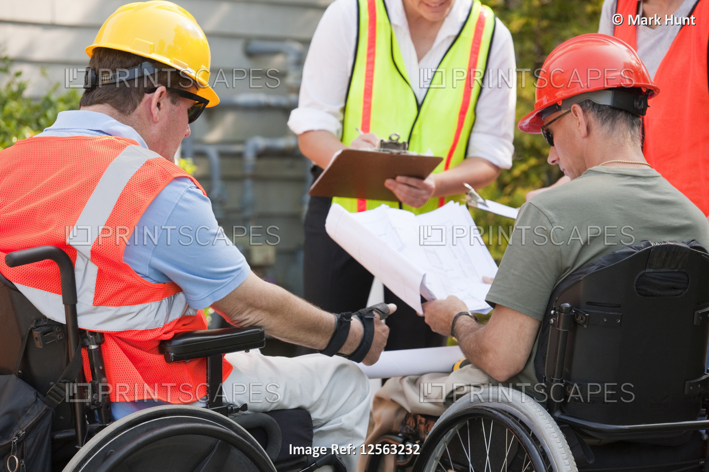 Project engineers with Spinal Cord Injuries discussing data at new building site