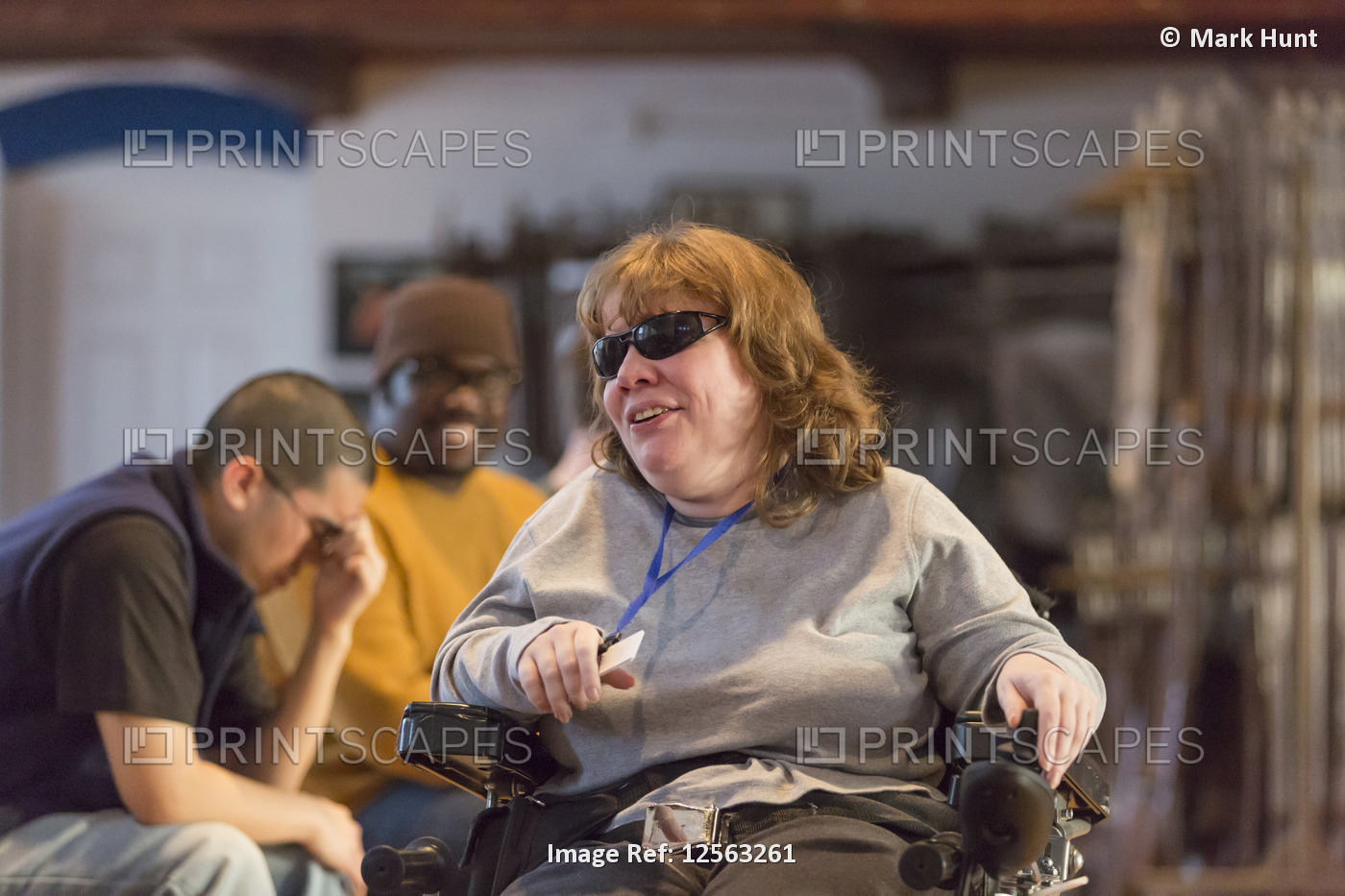Woman with Cerebral Palsy and Visual impairment talking with other people in a ...