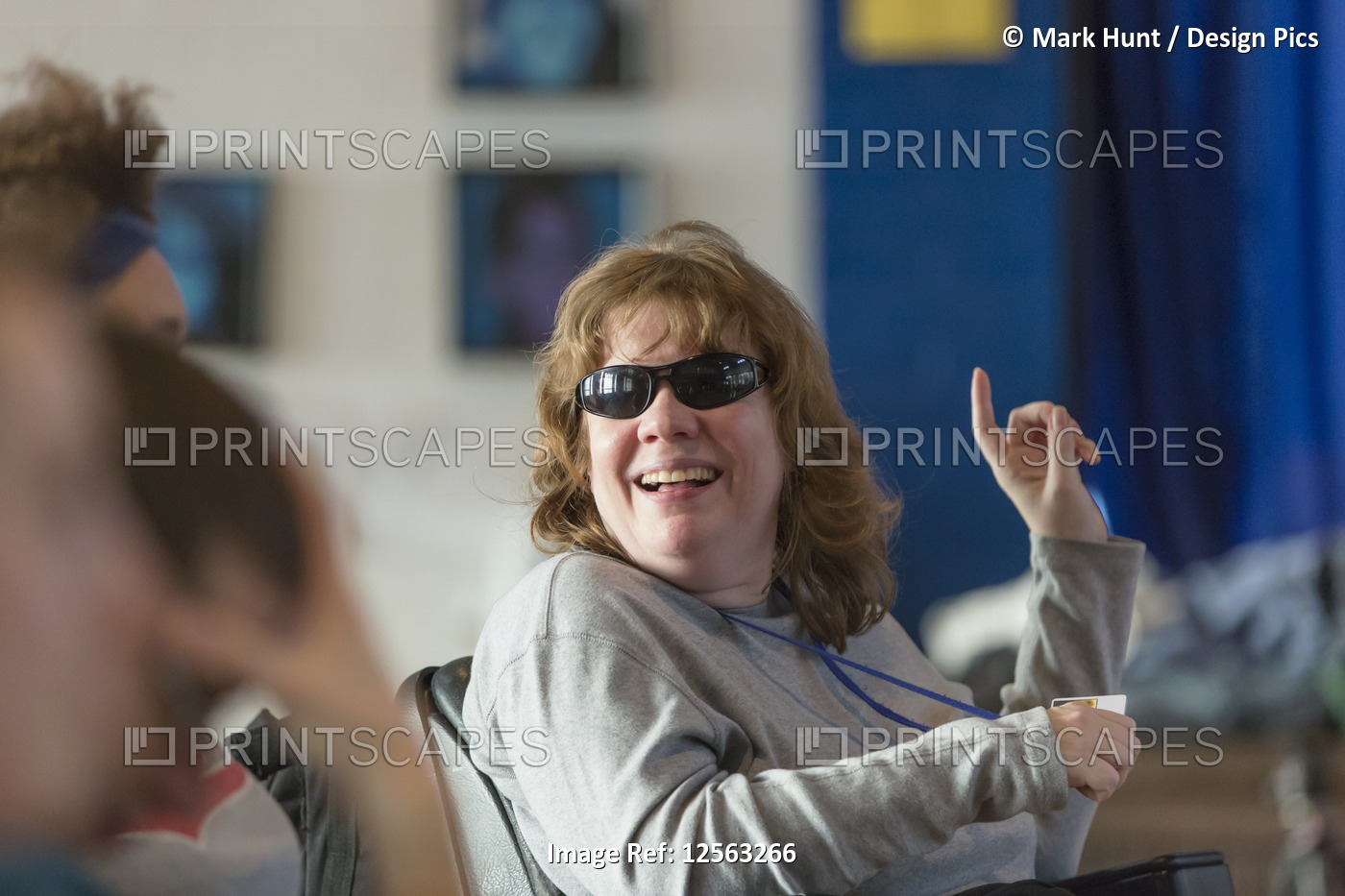 Woman with Cerebral Palsy and Visual impairment talking with other people in a ...