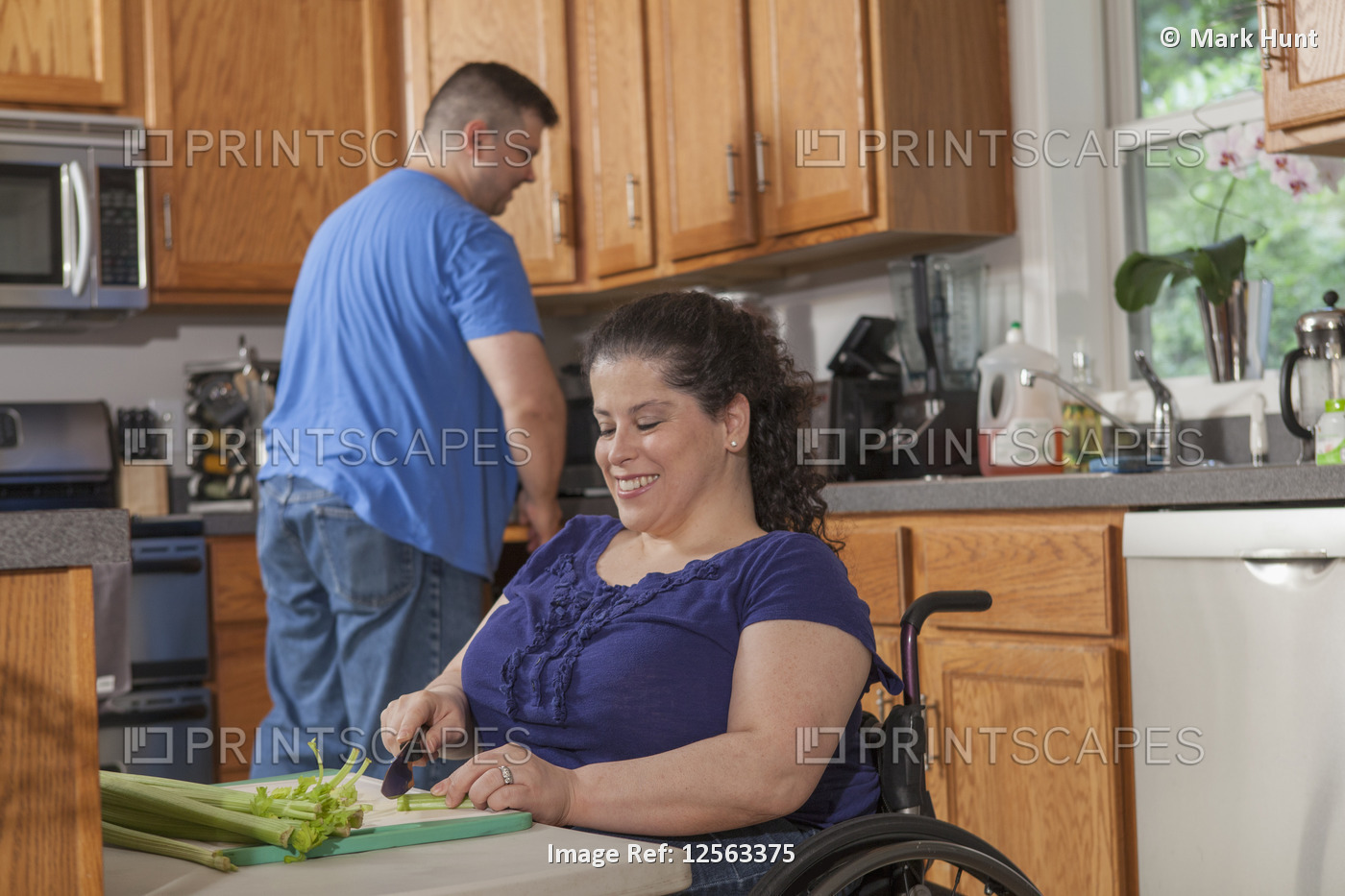 Woman with Spina Bifida and her husband preparing dinner in their kitchen