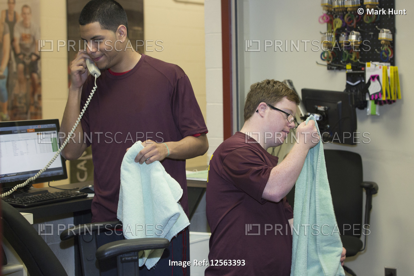 Young man with Down Syndrome preparing towels at college equipment dispensary ...