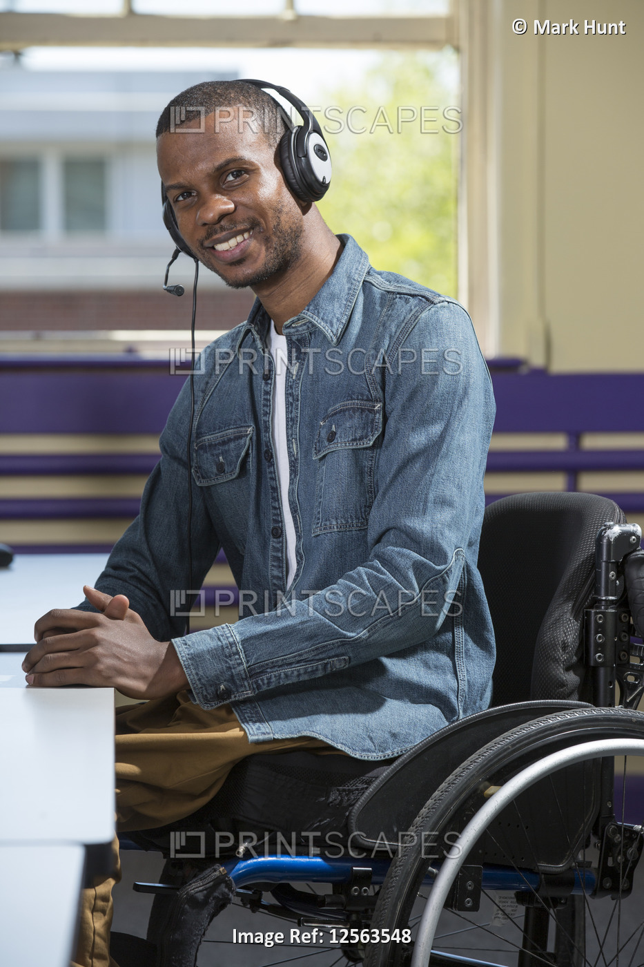 Man who had Spinal Meningitis in a wheelchair working at a booth in a call ...
