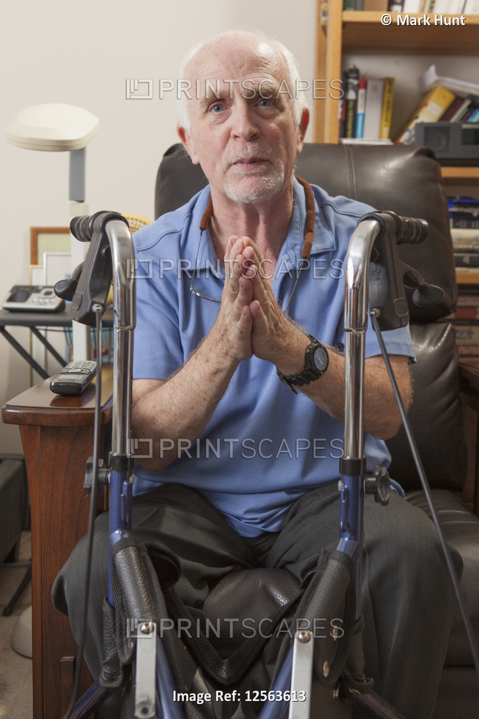 Man with Ataxia with his walker and gesturing in his bedroom