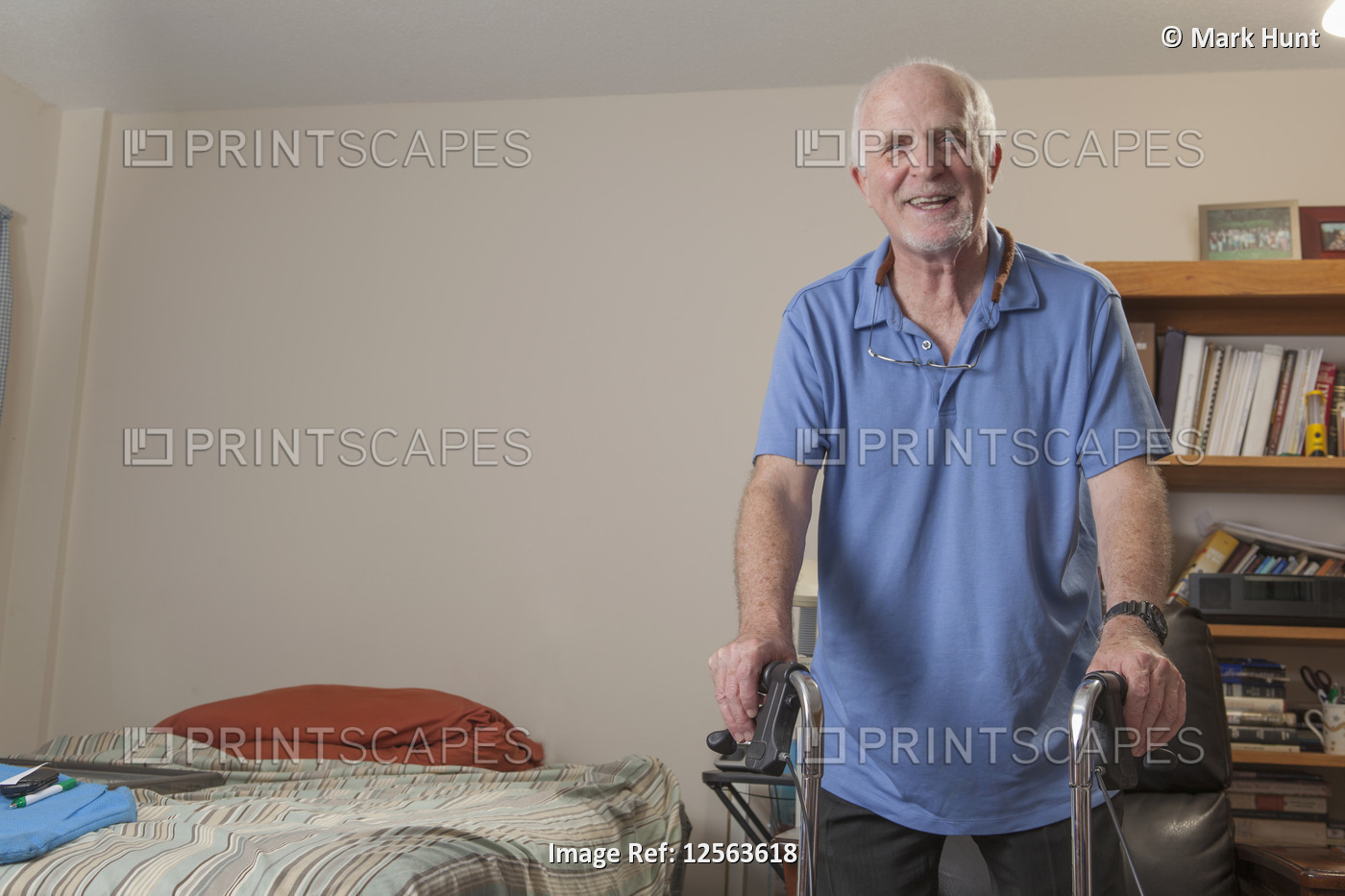 Man with Ataxia holding his walker to use in his bedroom