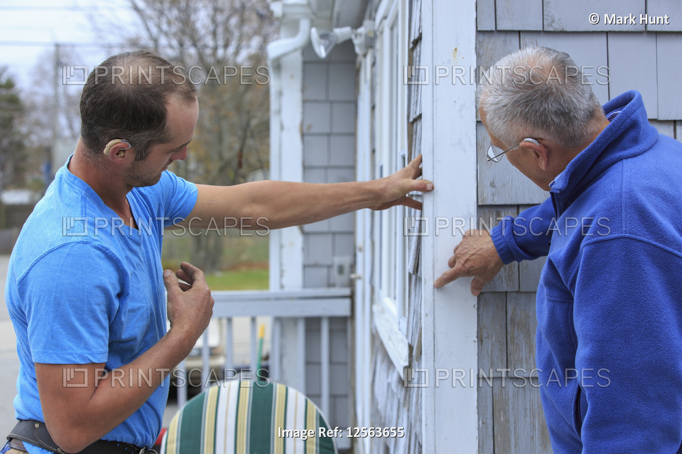 Homeowner communicating with home repair man in American Sign Language, saying ...