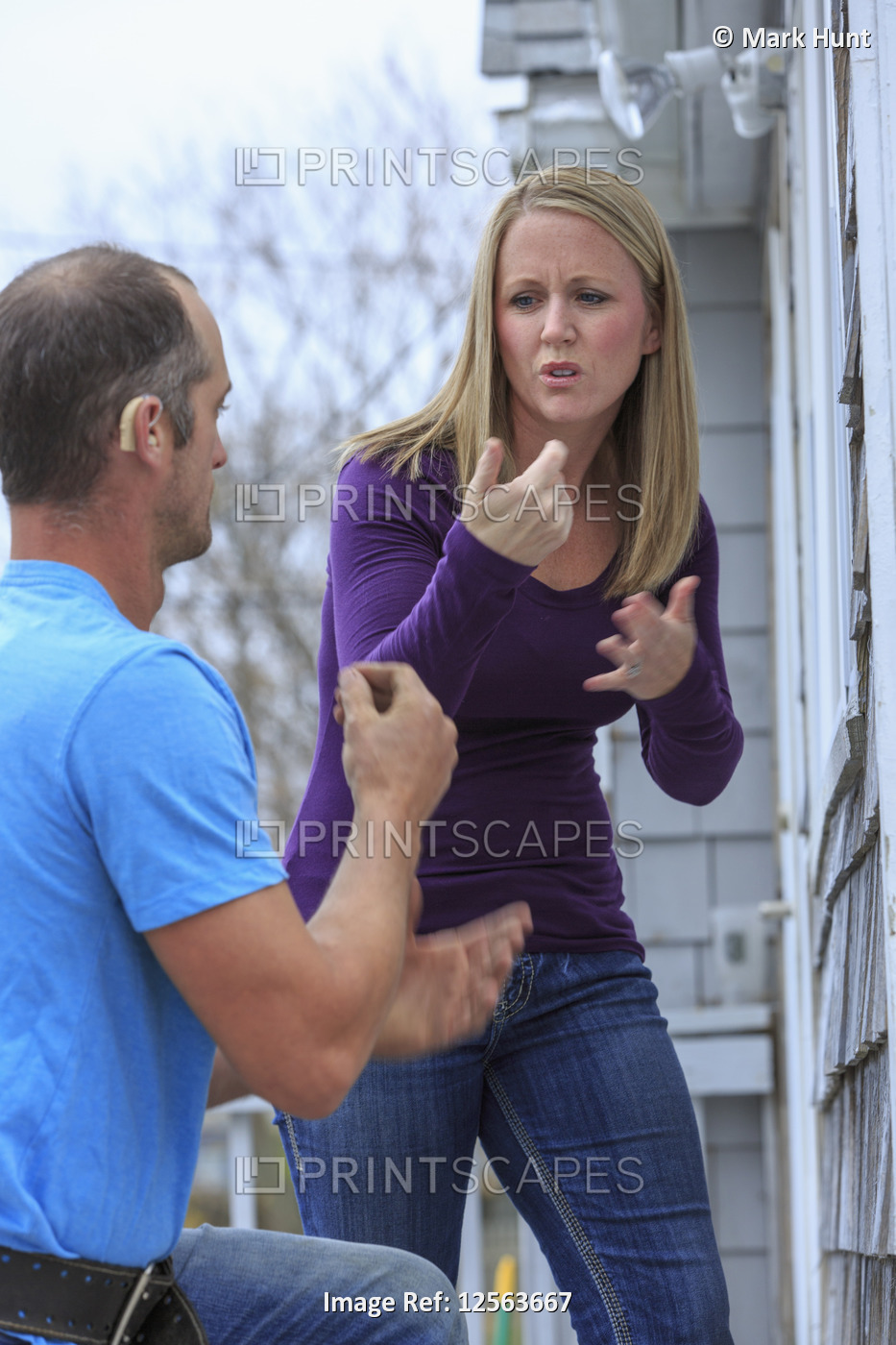 Homeowner communicating with home repairman in American Sign Language, saying ...
