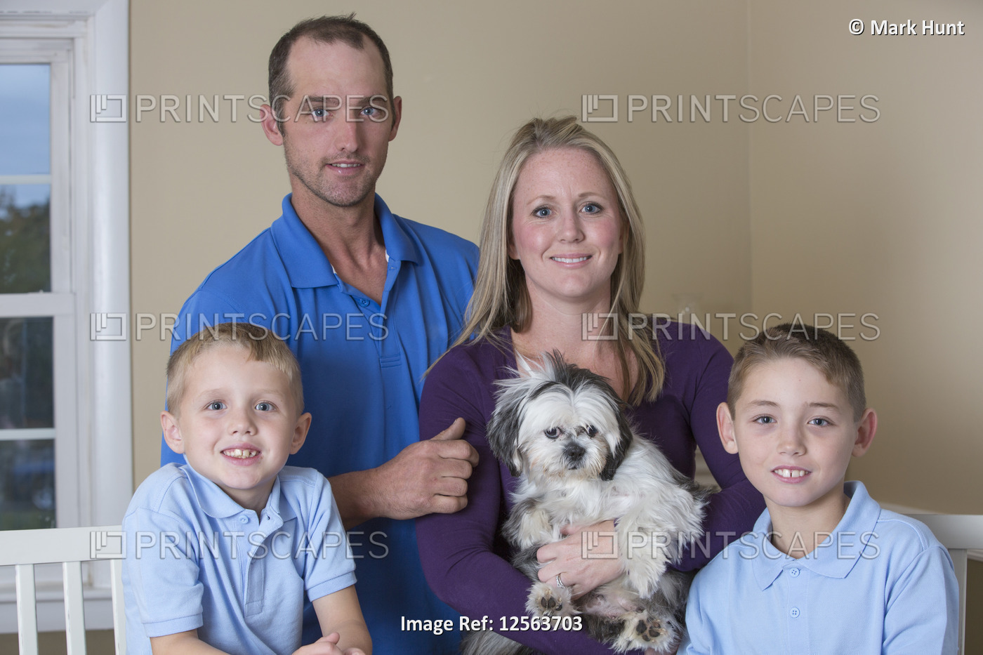 Portrait of a happy family with hearing impairments with a puppy