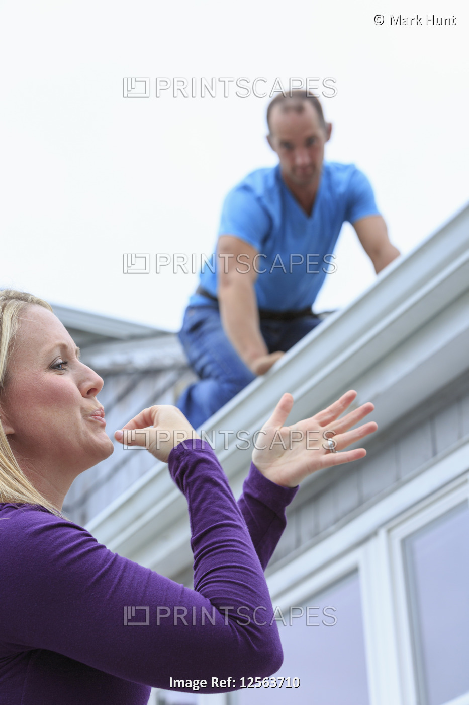 Homeowner and roofer communicating in American Sign Language about 'Soon'