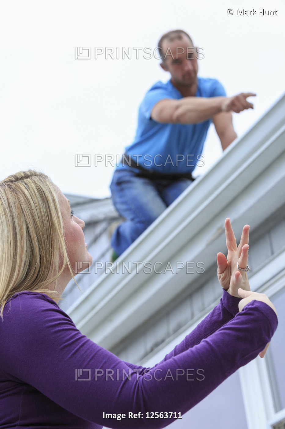 Homeowner and roofer communicating in American Sign Language about 'Leaking' ...