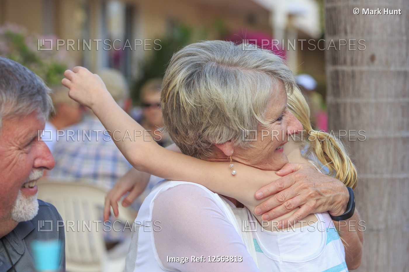 Loving grandparents and grandchild hugging