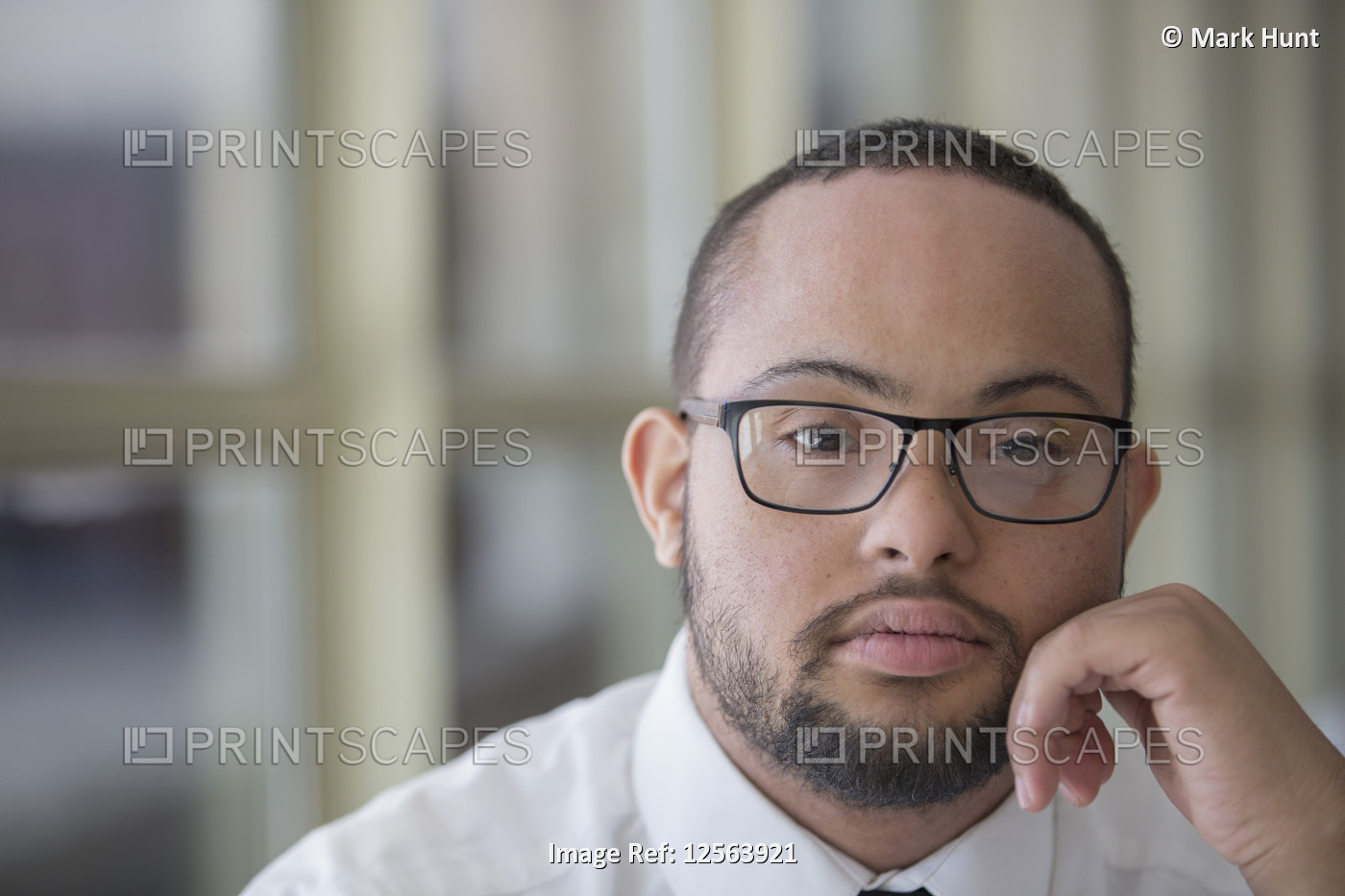 Portrait of African American man with Down Syndrome as a waiter in restaurant