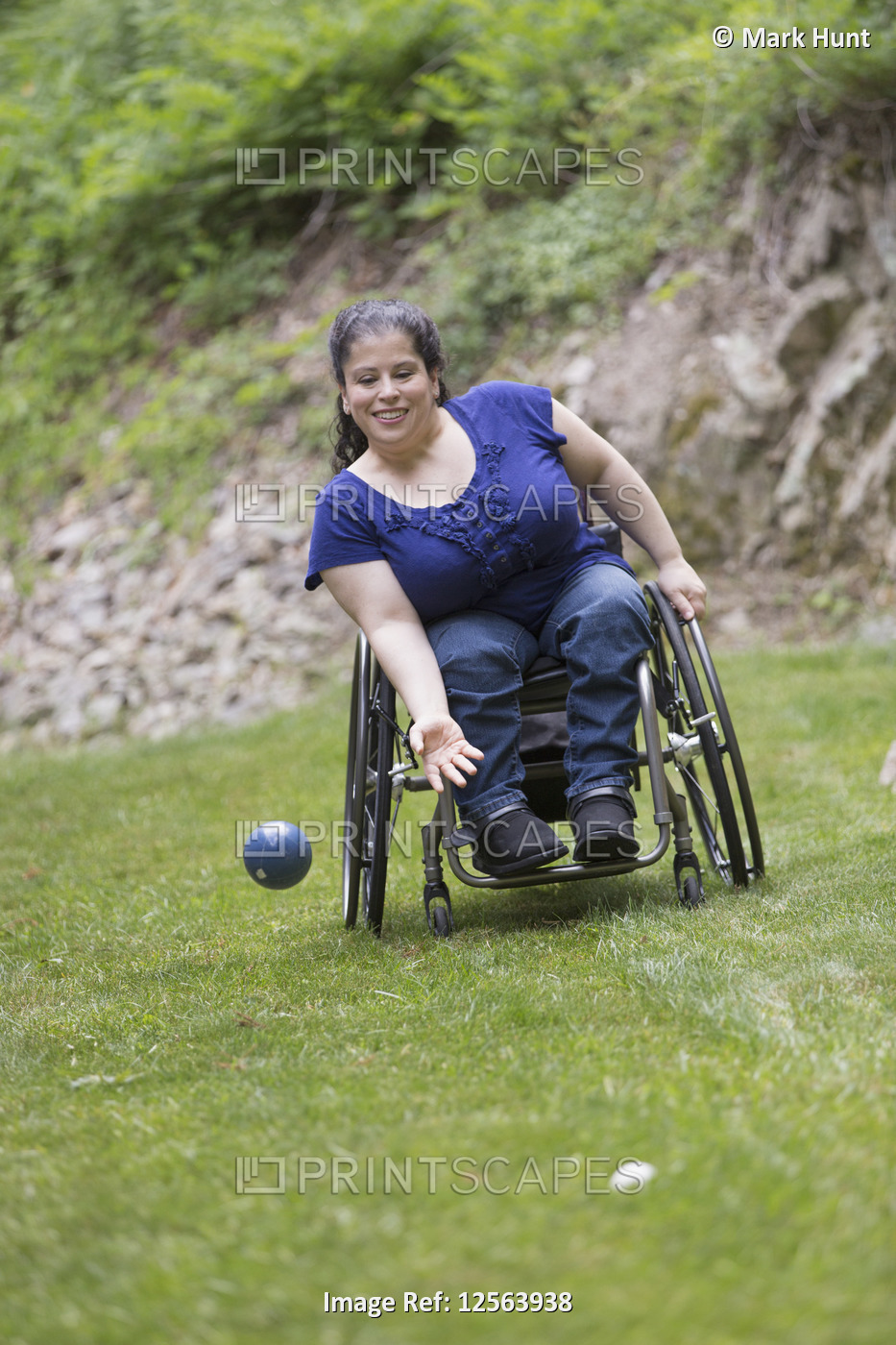 Woman with Spina Bifida in a wheelchair playing bocce ball