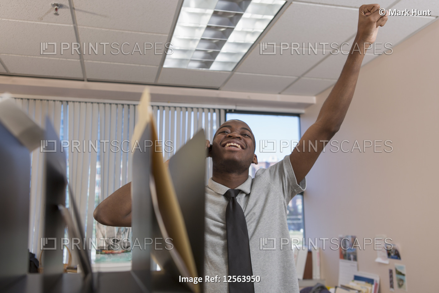 Portrait of happy African American man with Autism working in an office
