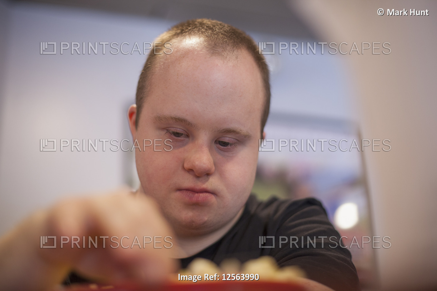 Waiter with Down Syndrome working in a restaurant