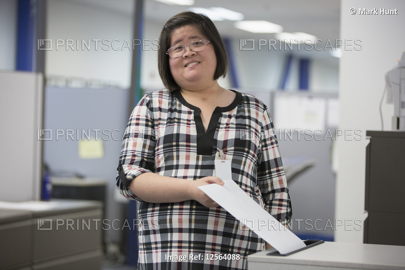 Asian woman with a Learning Disability working in an office