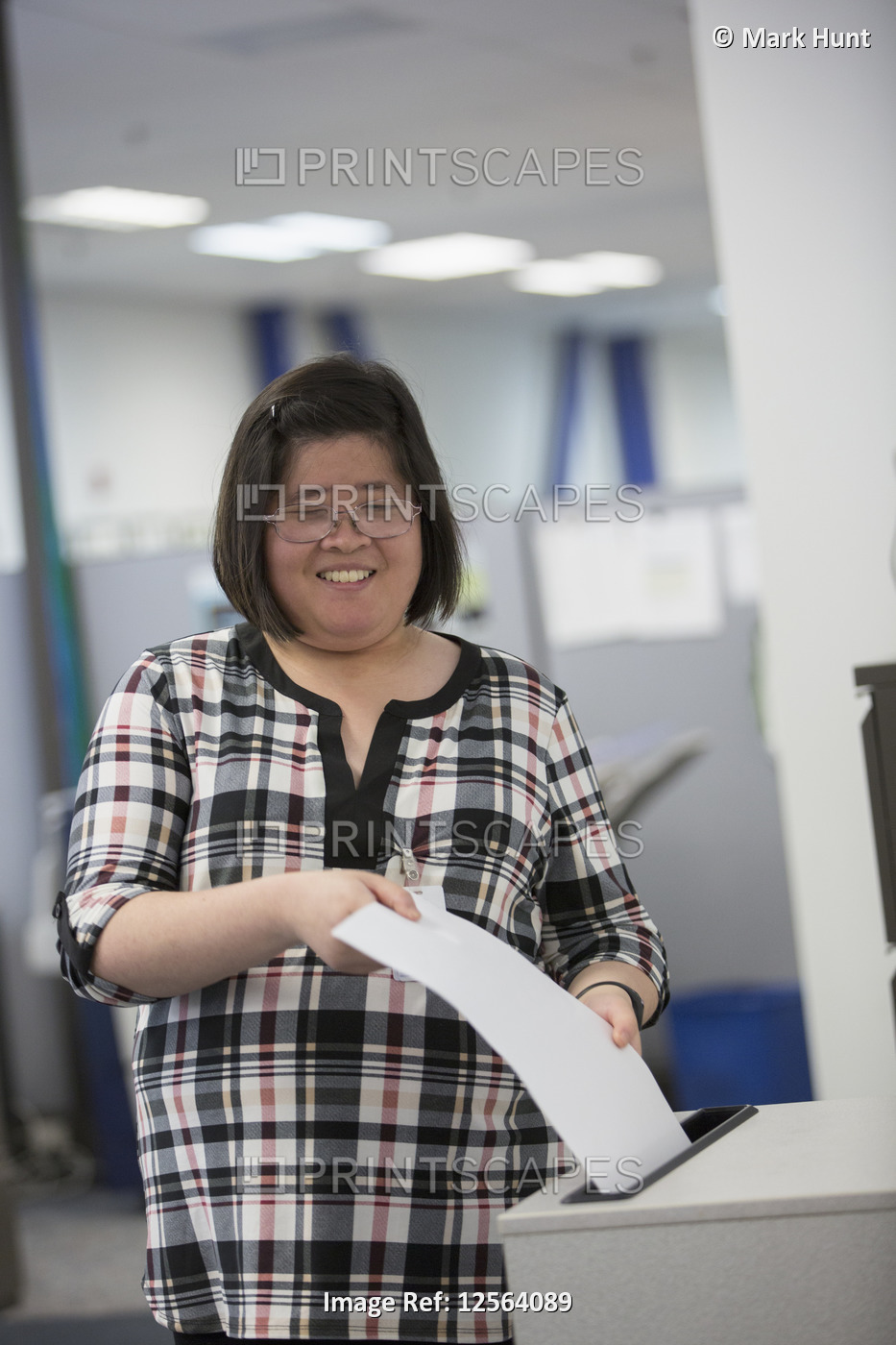 Asian woman with a Learning Disability working in an office