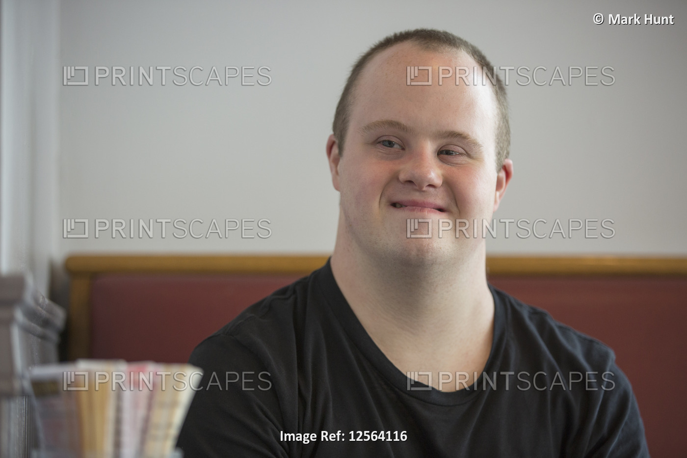 Portrait of waiter with Down Syndrome in a restaurant