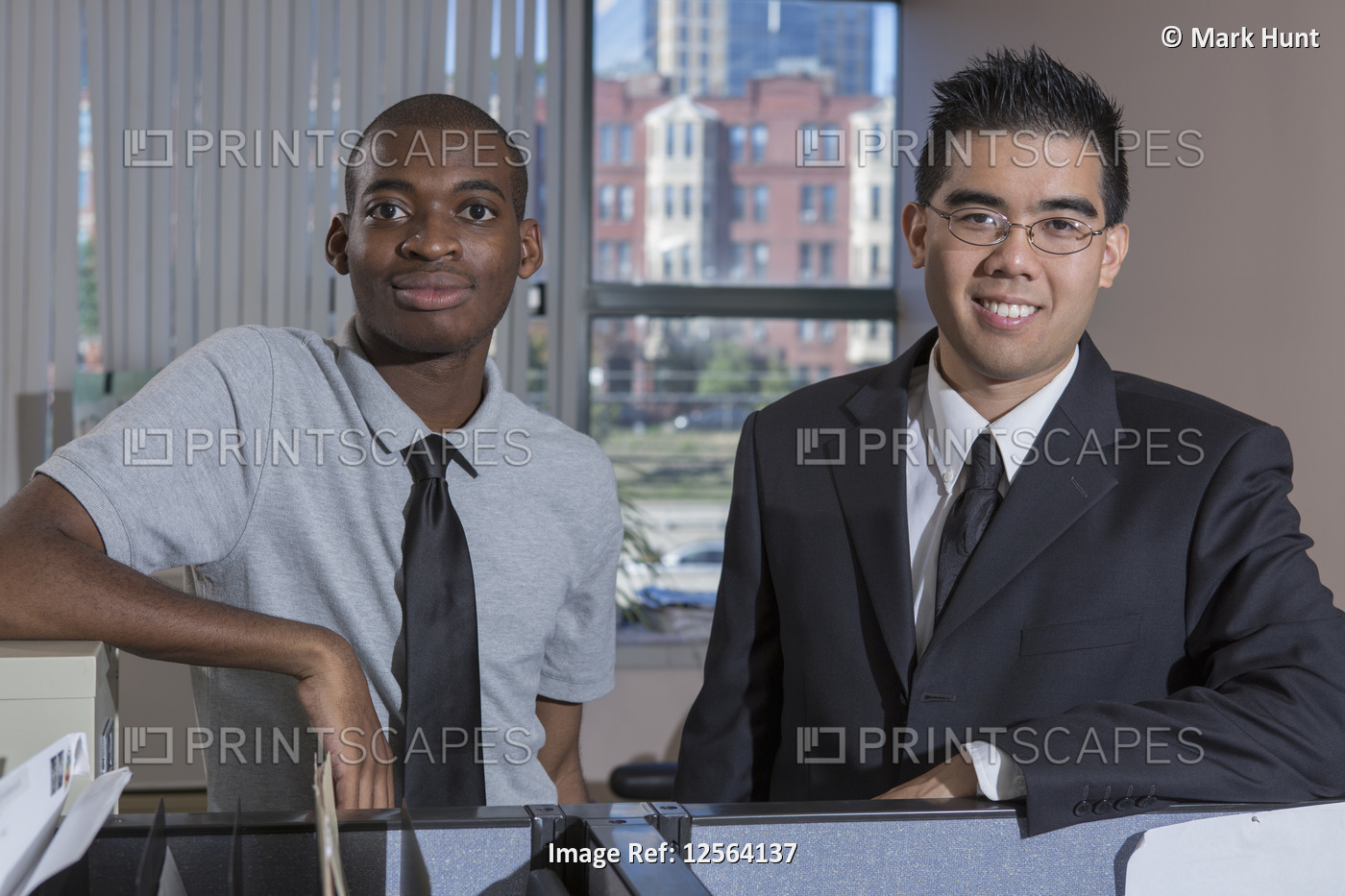 Portrait of two men with Autism smiling in an office