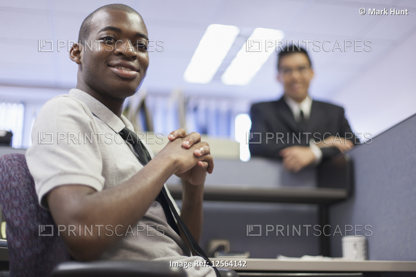 Happy portrait of two men with Autism working in an office