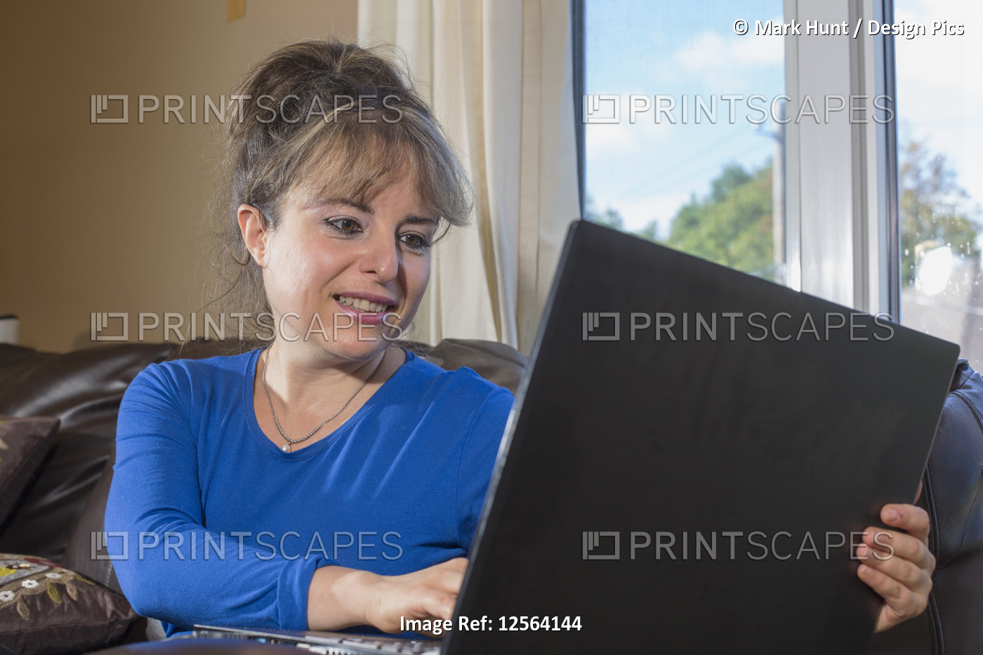 Woman with visual impairment working with her computer programs for the blind ...