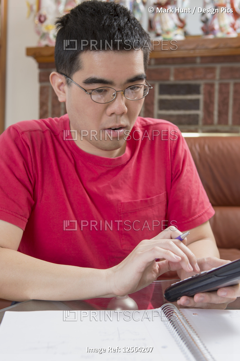 Asian man with Autism working on his cell phone