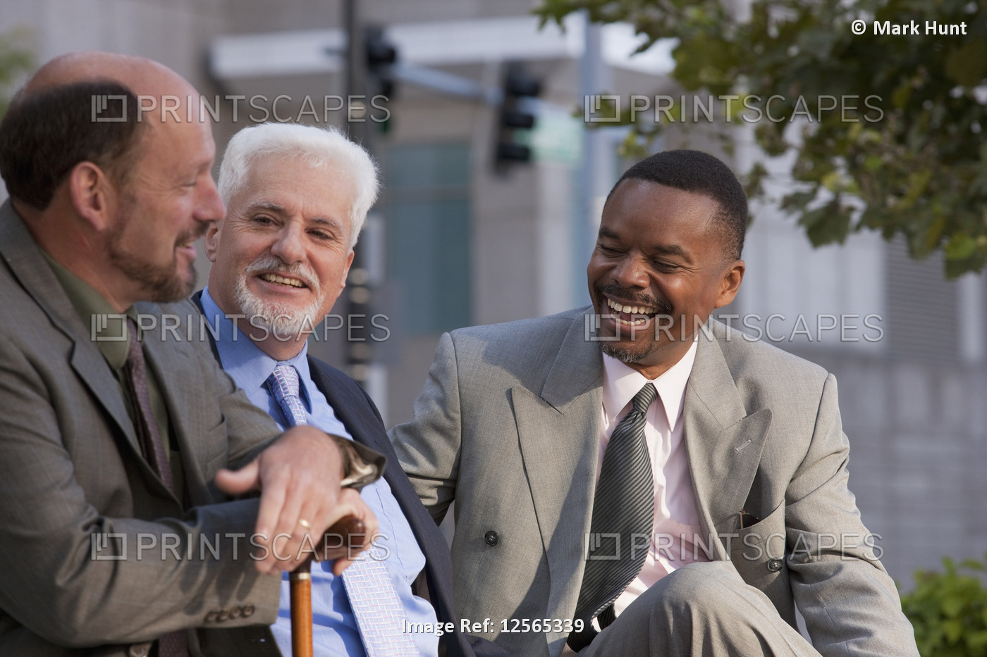 Businessmen talking and sharing insights, with one businessman holding a cane